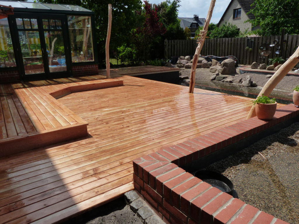 Holzterrasse angrenzend an den Schwimmbereich in Gifhorn, Niedersachsen.